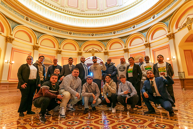 A group of students posing inside the Sacramento Capitol building.