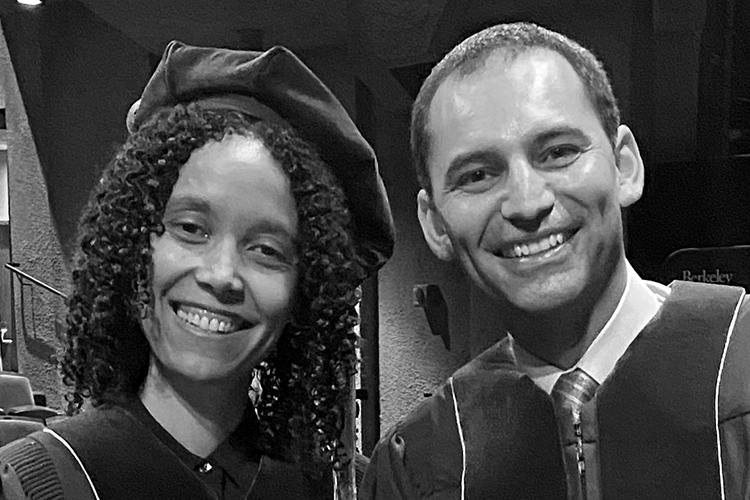 black and white photo of two students wearing caps and gowns